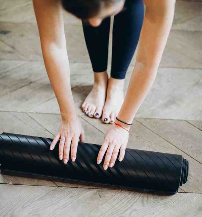 Woman Preparing Her Yoga Mat